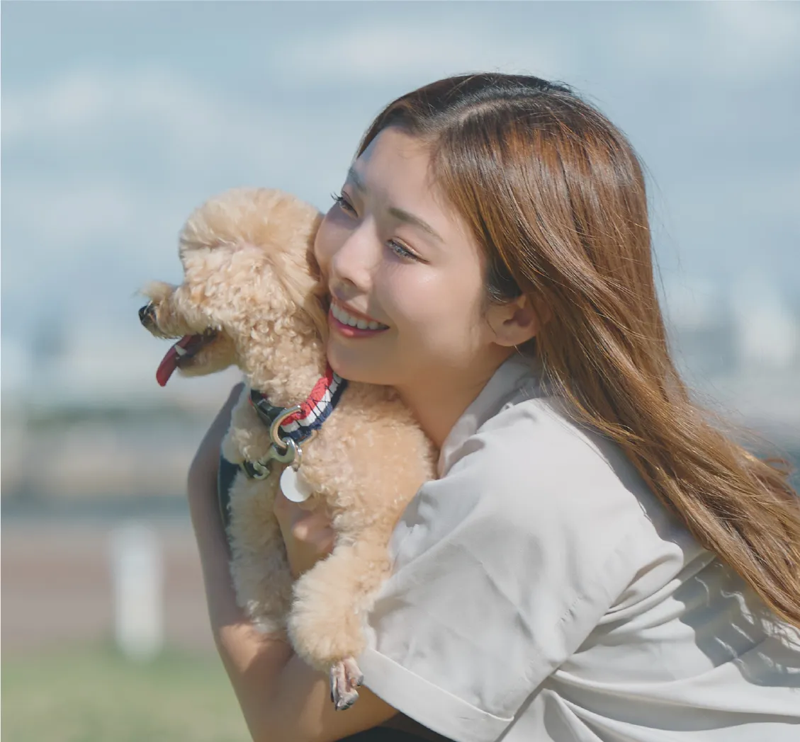 女性が愛犬を抱っこする様子
